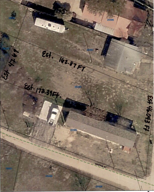 an aerial view of residential houses with parking space