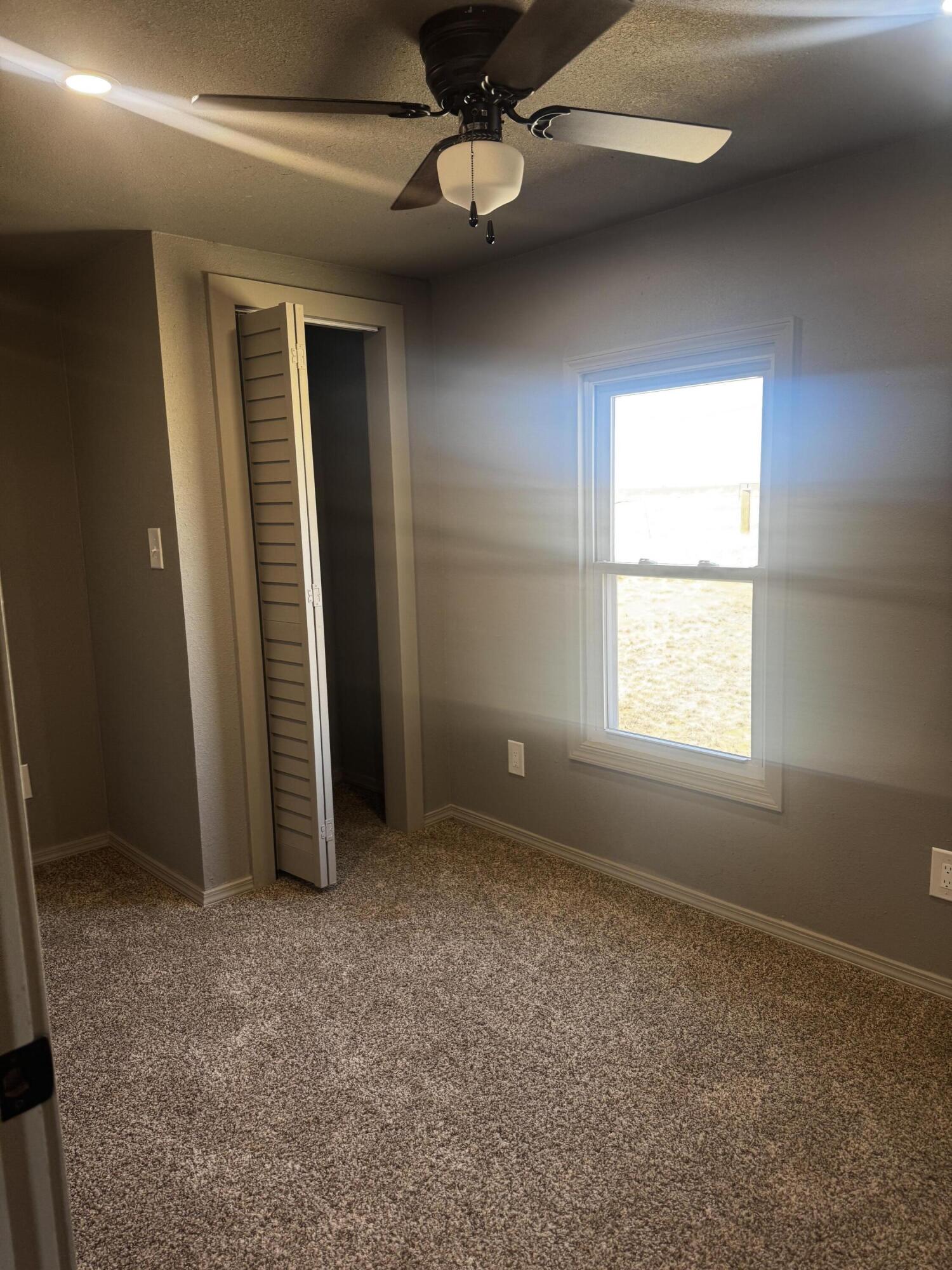 1128 Alaska Road Levelland, TX 79336 - Photo 15 of 20 an empty room with windows and fan
