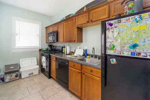 a kitchen that has a sink and a stove in it