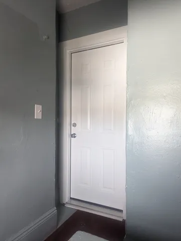 a view of room with window and wooden floor