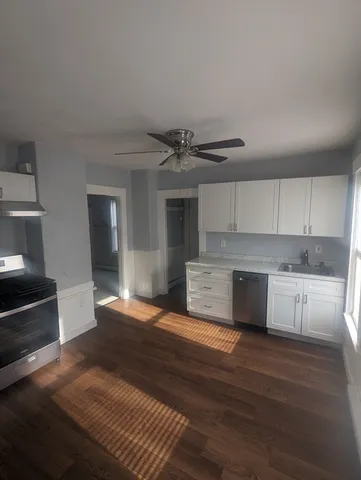a kitchen with a refrigerator stove and cabinets