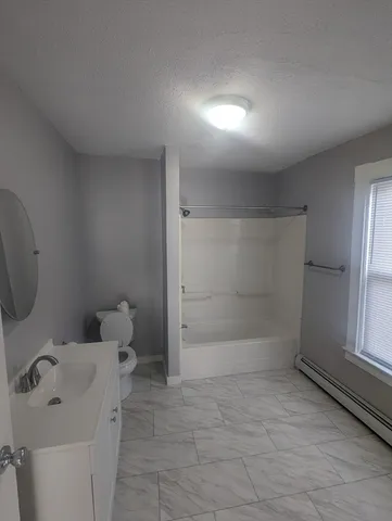 a bathroom with a toilet sink and shower