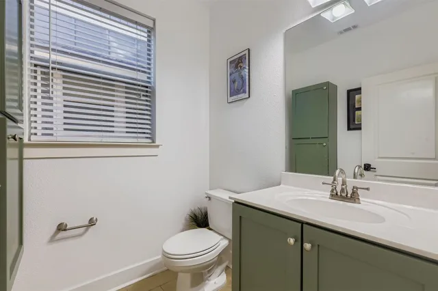 a bathroom with a sink toilet and mirror