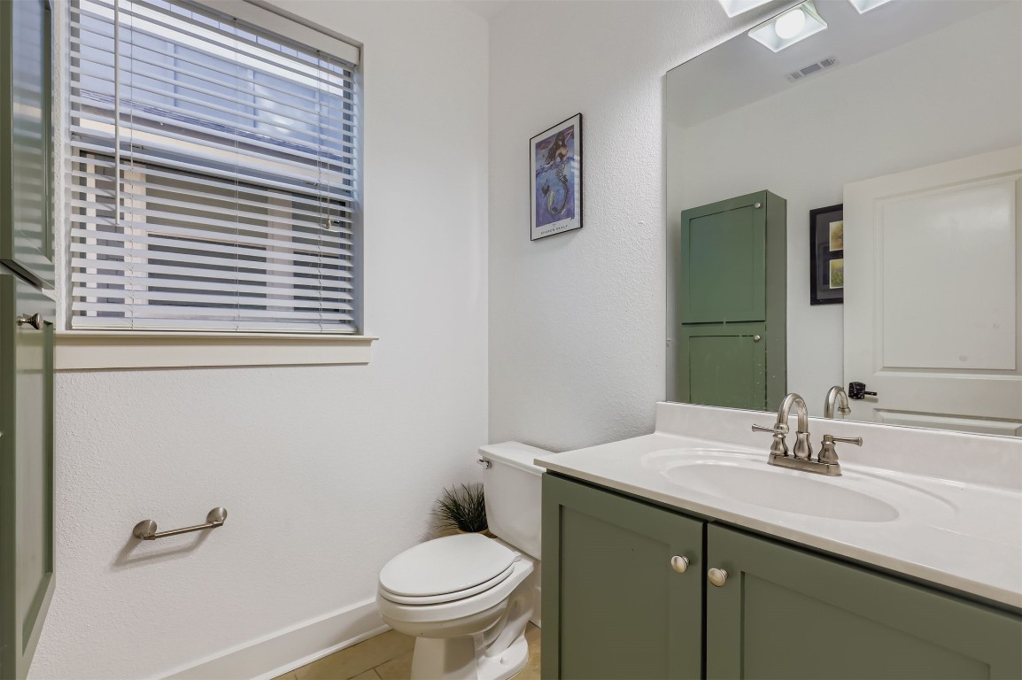 1601 Miriam Avenue, Unit 302 Austin, TX 78702 - Photo 13 of 29 Half bath featuring vanity, light tile patterned floors, and a skylight