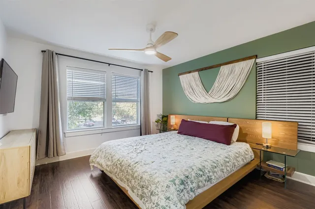 a bedroom with a bed and wooden floor