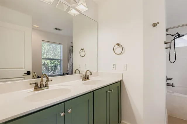 a bathroom with a sink vanity and mirror