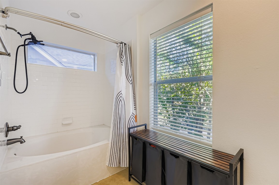 1601 Miriam Avenue, Unit 302 Austin, TX 78702 - Photo 18 of 29 Bathroom featuring shower / tub combo and light tile patterned flooring