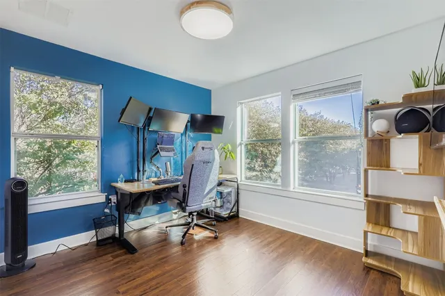 a view of a livingroom with workspace and a window