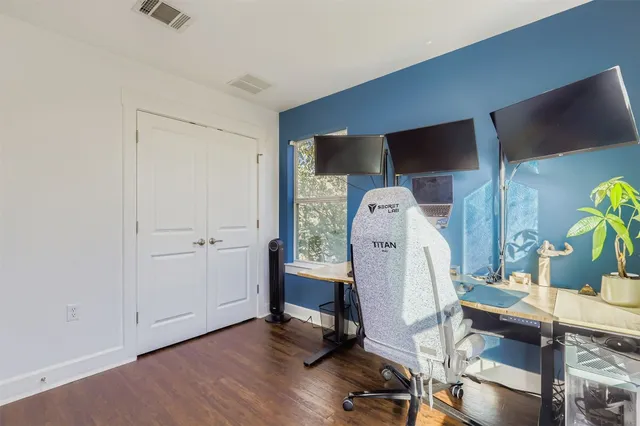 a view of dining room with wooden floor and furniture