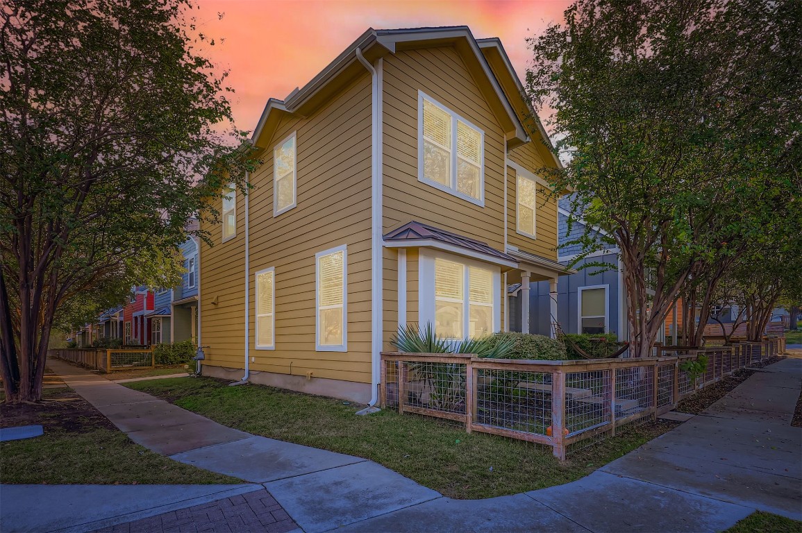 1601 Miriam Avenue, Unit 302 Austin, TX 78702 - Photo 26 of 29 Property exterior at dusk with a fenced front yard