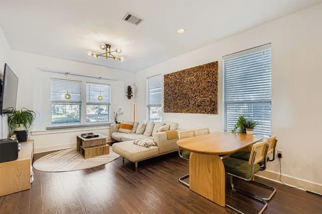 a living room with furniture and wooden floor
