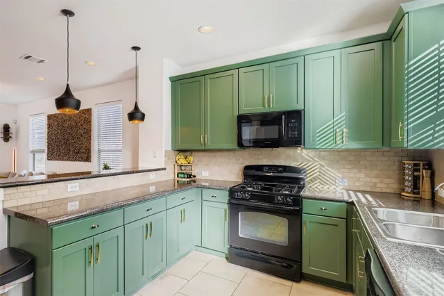 a kitchen with a sink stove and microwave