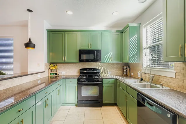 a kitchen with a sink stove and cabinets