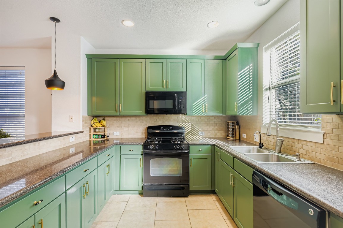 1601 Miriam Avenue, Unit 302 Austin, TX 78702 - Photo 9 of 29 Kitchen with green cabinets, black appliances, decorative light fixtures, light tile patterned floors, and recessed lighting