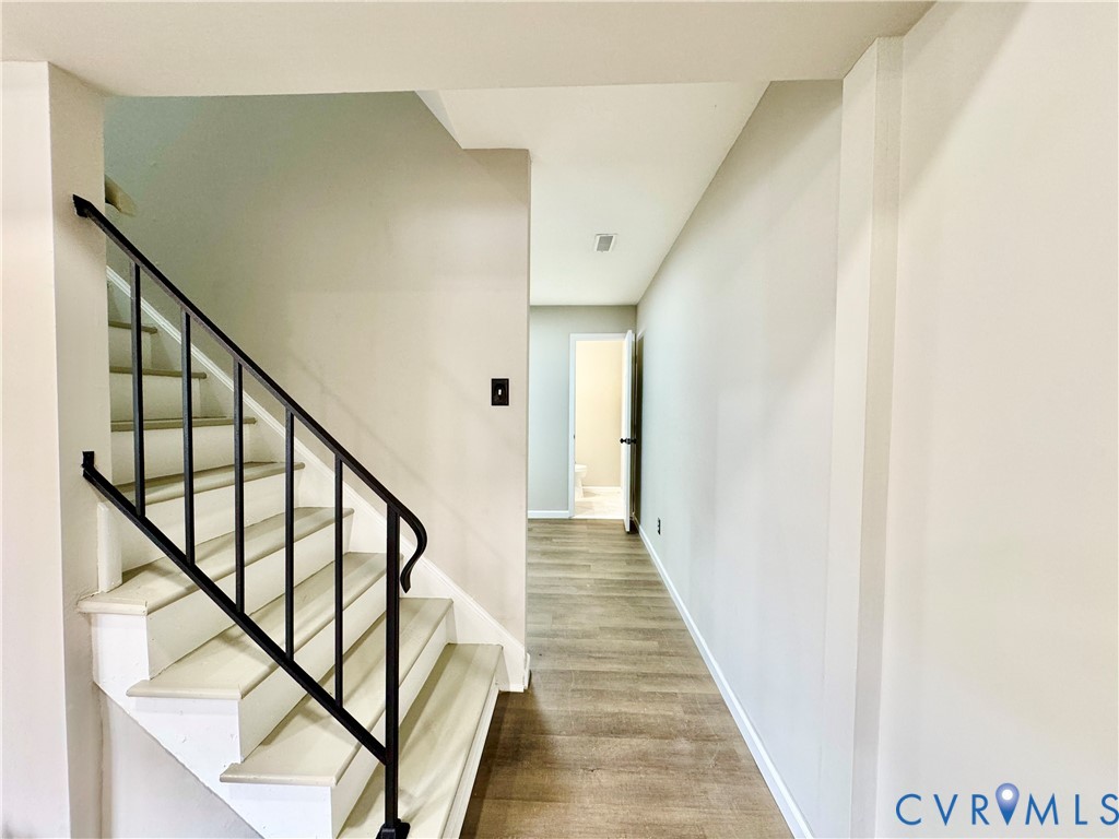 403 Roxana Road Henrico, VA 23075 - Photo 16 of 42 Staircase with black metal railing, white risers,