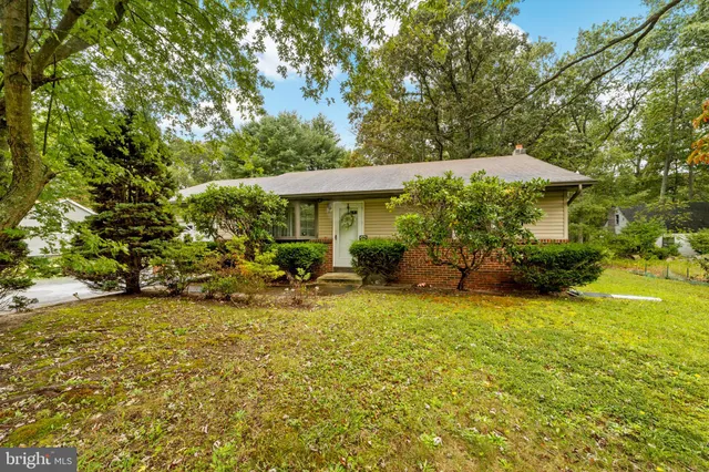 a view of a patio with table and chairs under an umbrella