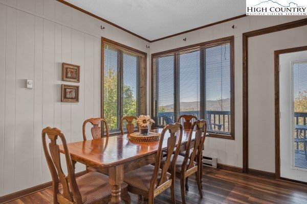 144 Skyleaf Lane, Unit 703 Sugar Mountain, NC 28604 - Photo 11 of 29 a dining room with furniture window and wooden floor