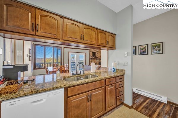 144 Skyleaf Lane, Unit 703 Sugar Mountain, NC 28604 - Photo 12 of 29 a kitchen with granite countertop stainless steel appliances a sink and cabinets