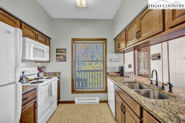 144 Skyleaf Lane, Unit 703 Sugar Mountain, NC 28604 - Photo 14 of 29 a kitchen that has a sink and a stove