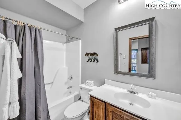 a bathroom with a sink toilet a shower and a mirror