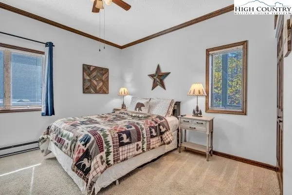 a bedroom with a bed lamp and paintings on the wall