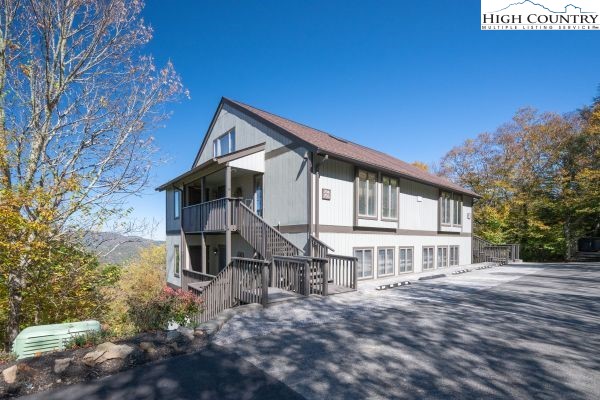144 Skyleaf Lane, Unit 703 Sugar Mountain, NC 28604 - Photo 2 of 29 a front view of a house with a porch
