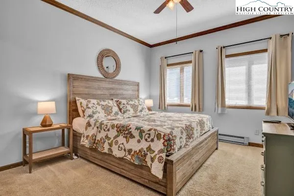 a bed sitting in a bedroom next to a window