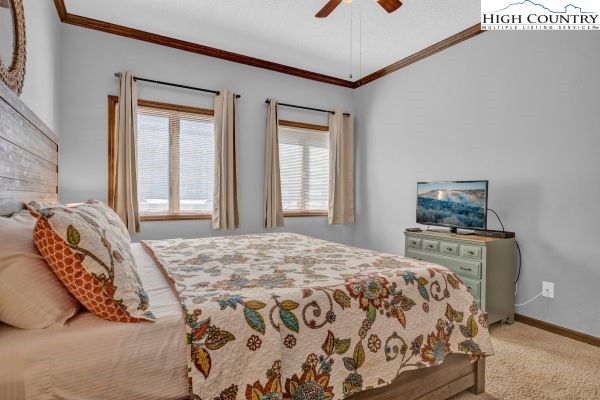 144 Skyleaf Lane, Unit 703 Sugar Mountain, NC 28604 - Photo 22 of 29 a bedroom with a bed and a window