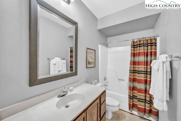 144 Skyleaf Lane, Unit 703 Sugar Mountain, NC 28604 - Photo 23 of 29 a bathroom with a sink toilet and shower