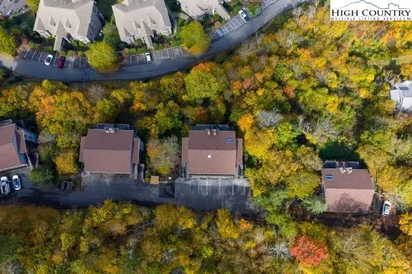 an aerial view of a house with a yard swimming pool and outdoor seating