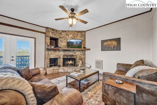 a living room with furniture a fireplace and a large window