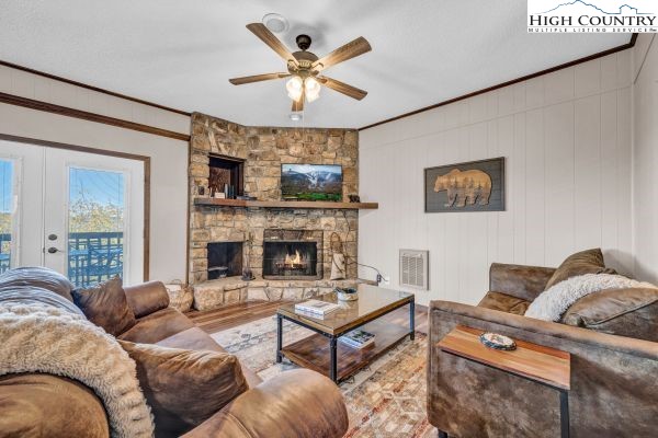 144 Skyleaf Lane, Unit 703 Sugar Mountain, NC 28604 - Photo 4 of 29 a living room with furniture a fireplace and a large window