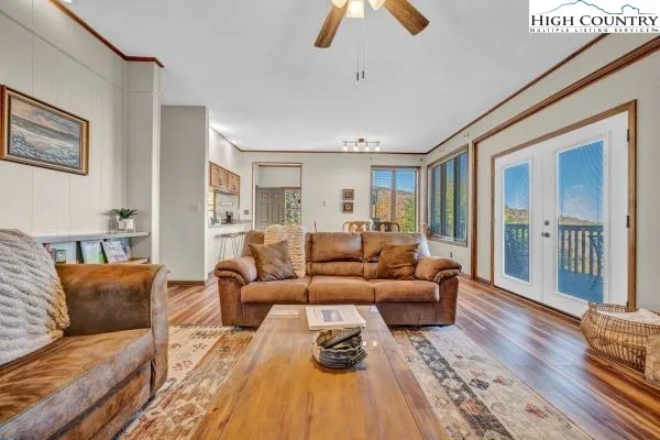 a living room with furniture and a wooden floor