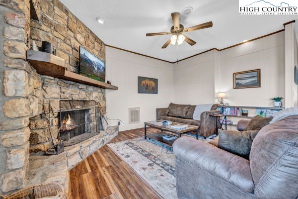 144 Skyleaf Lane, Unit 703 Sugar Mountain, NC 28604 - Photo 8 of 29 a living room with furniture and a fireplace