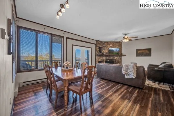 a dining room with furniture window and wooden floor