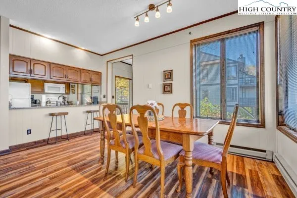 a dining room with furniture and wooden floor