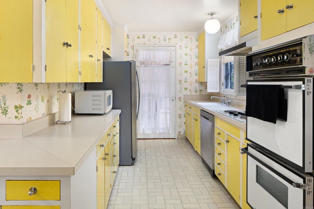 1380 Park Row La Jolla, CA 92037 - Photo 15 of 51 a kitchen with stainless steel appliances a stove refrigerator and a microwave
