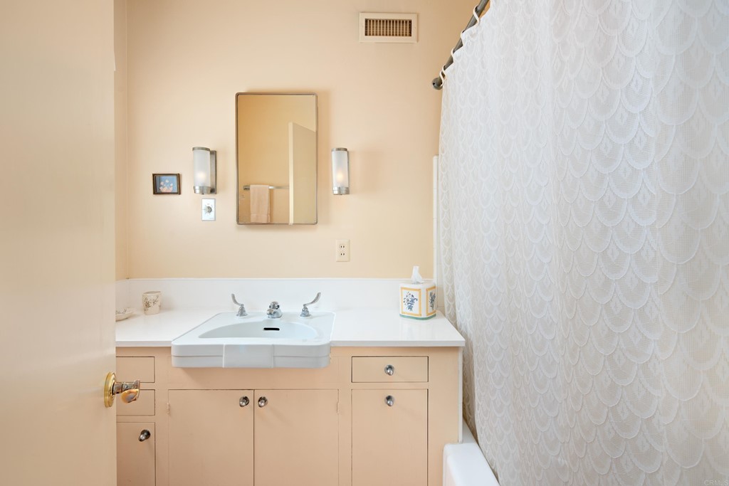 1380 Park Row La Jolla, CA 92037 - Photo 26 of 51 a bathroom with a sink and a mirror