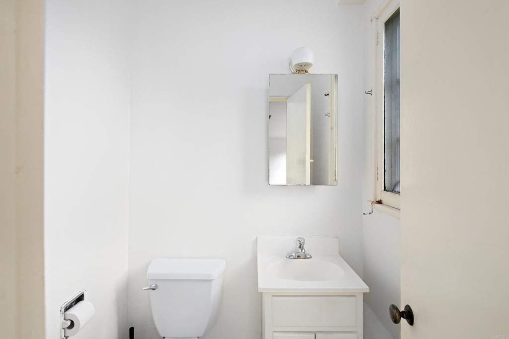 1380 Park Row La Jolla, CA 92037 - Photo 35 of 51 a bathroom with a toilet sink and mirror