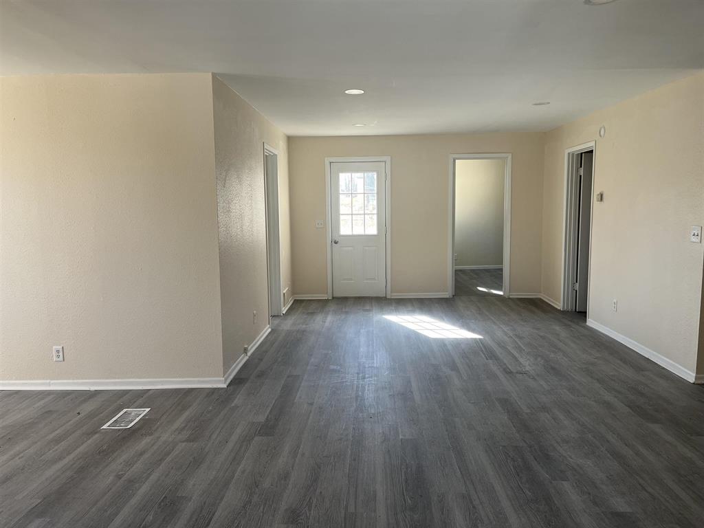 458 South Float Avenue Freeport, IL 61032 - Photo 3 of 11 an empty room with wooden floor and windows