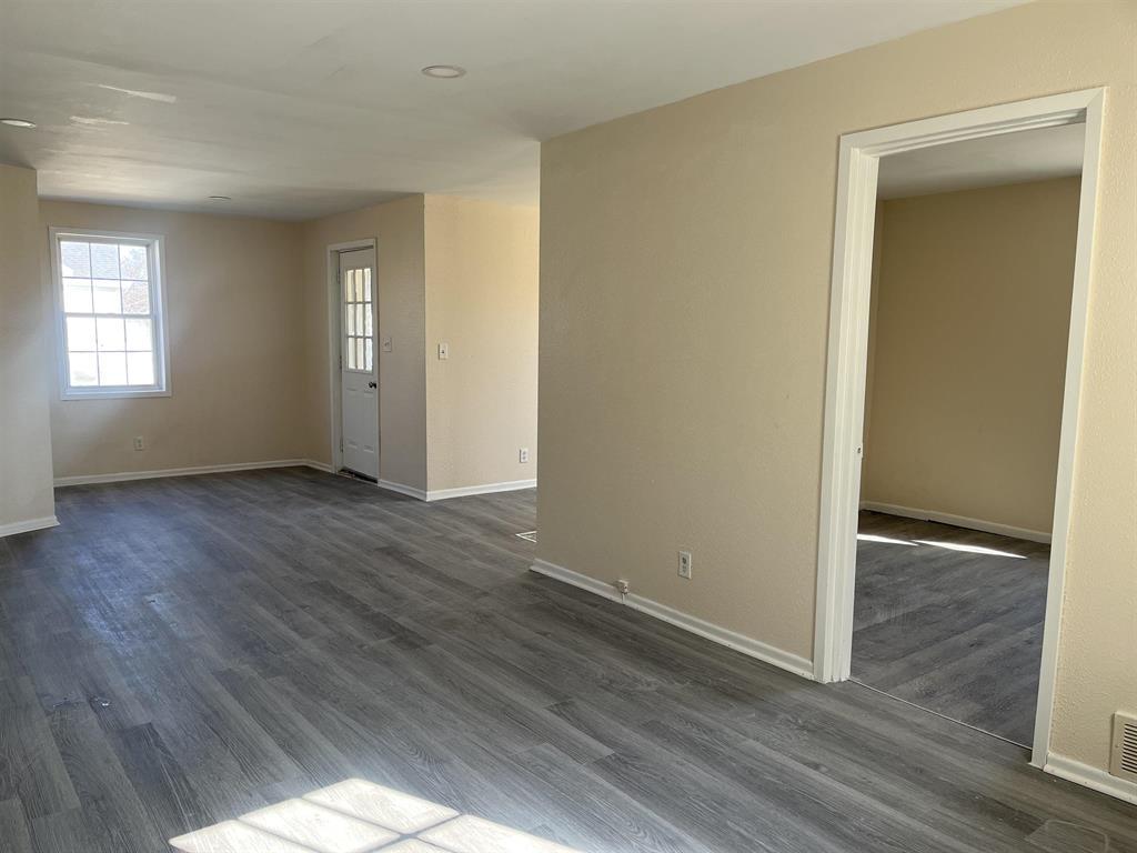 458 South Float Avenue Freeport, IL 61032 - Photo 4 of 11 an empty room with wooden floor and windows