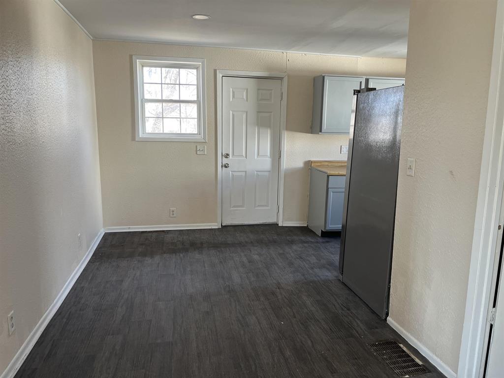 458 South Float Avenue Freeport, IL 61032 - Photo 6 of 11 an empty room with wooden floor and a window