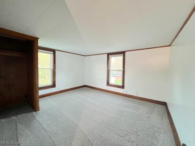 1918 Wainwright Road New Philadelphia, OH 44663 - Photo 14 of 24 Unfurnished room with light carpet and plenty of natural light