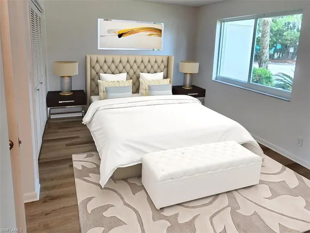 a bed sitting in a bedroom next to a window