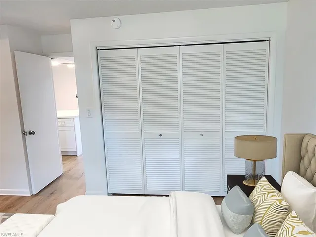 a bedroom with a bed and a chair