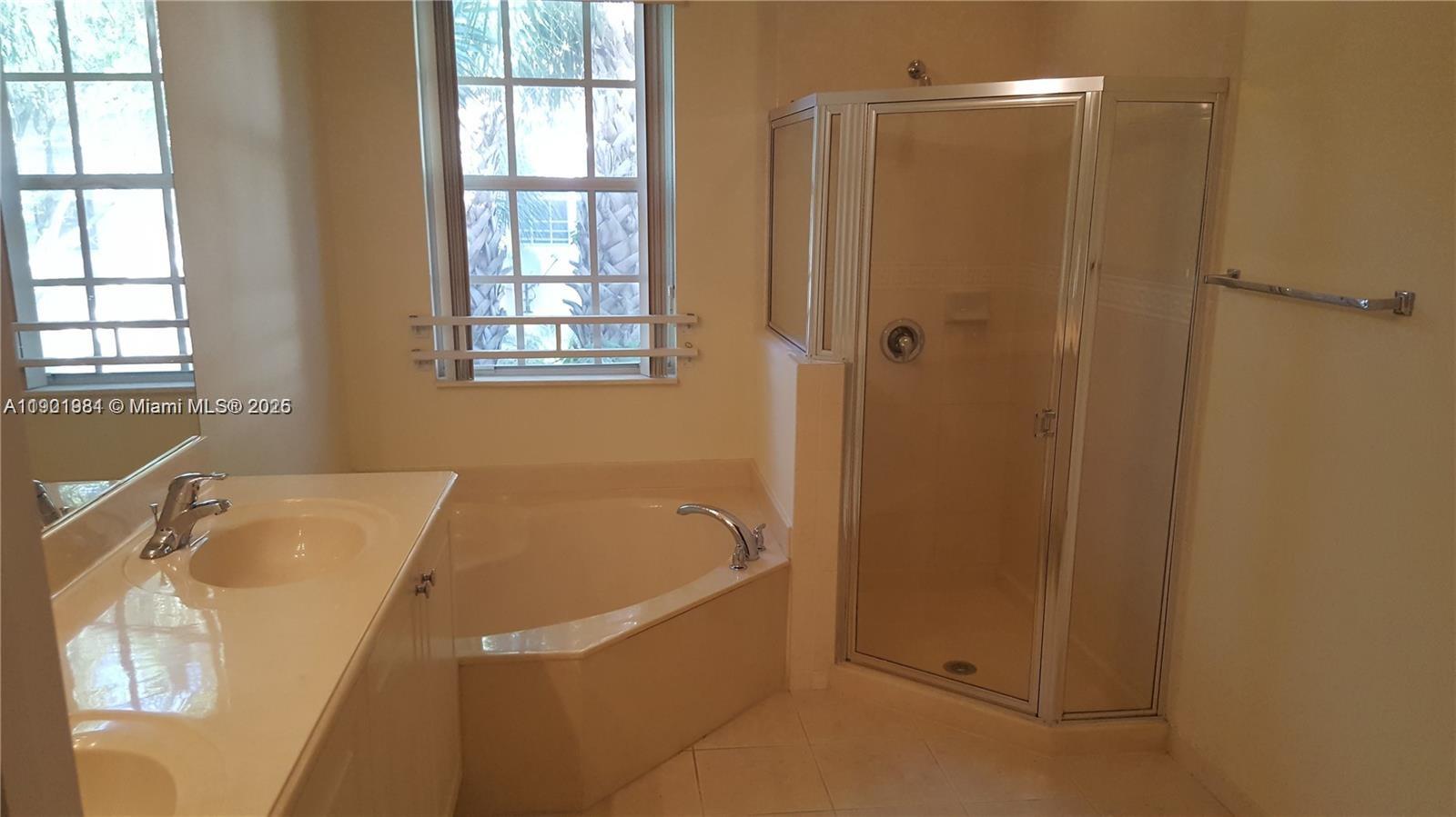 2853 Southwest 85th Avenue, Unit 103 Miramar, FL 33025 - Photo 16 of 20 a bathroom with a tub sink and window