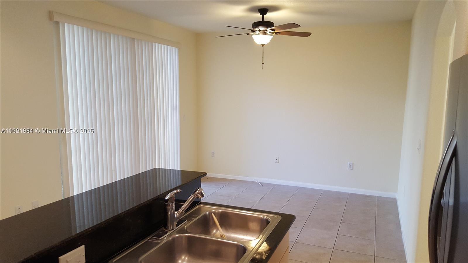 2853 Southwest 85th Avenue, Unit 103 Miramar, FL 33025 - Photo 2 of 20 a view of room with a ceiling fan