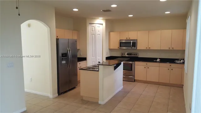 a kitchen with a refrigerator and a stove