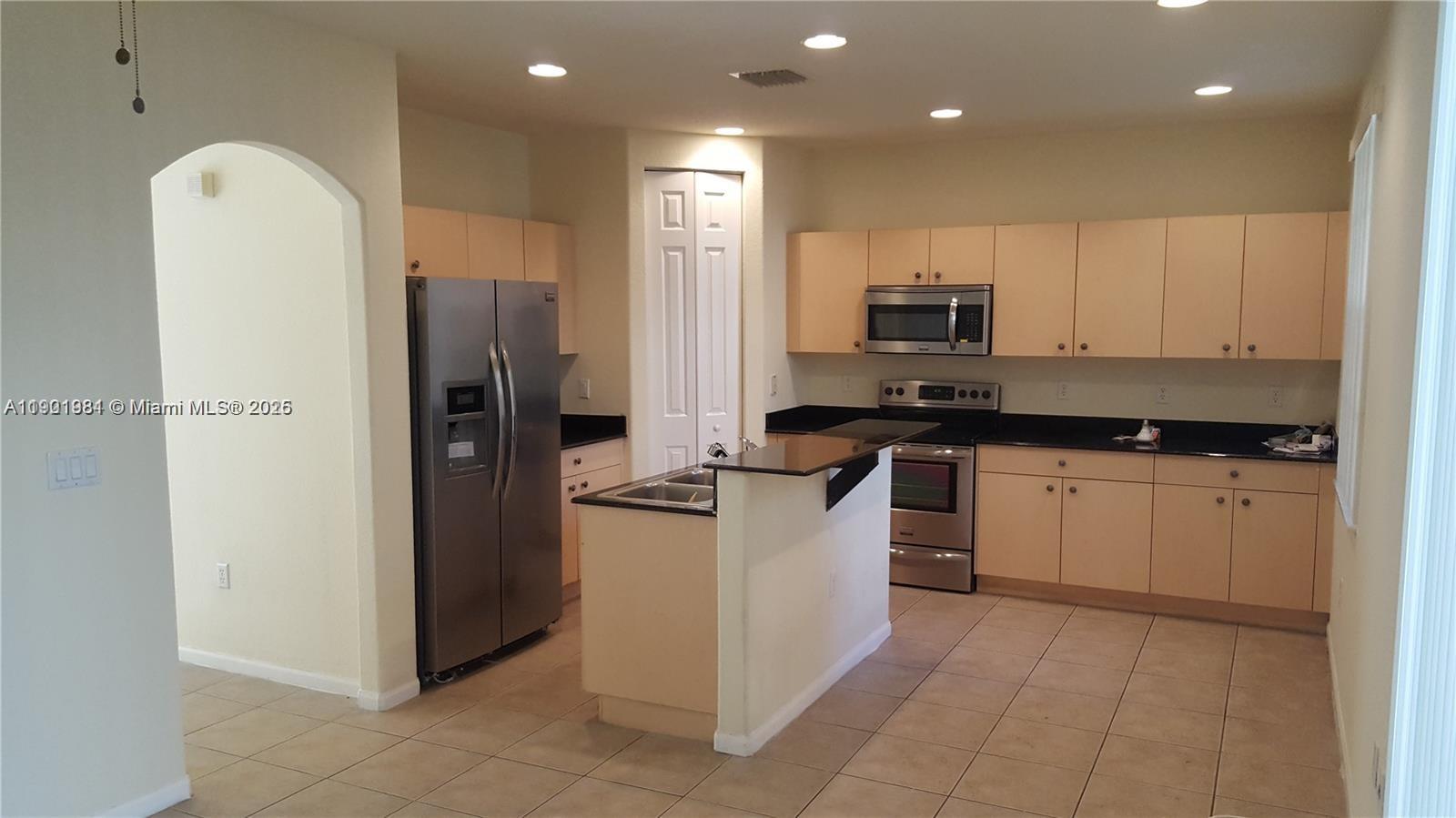 2853 Southwest 85th Avenue, Unit 103 Miramar, FL 33025 - Photo 3 of 20 a kitchen with a refrigerator and a stove