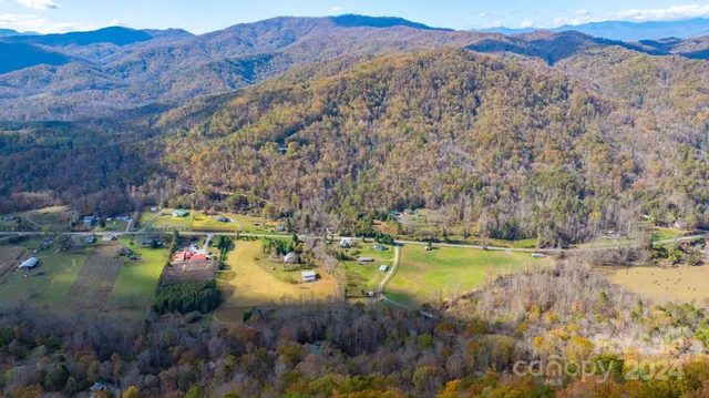 a view of a mountain with a yard